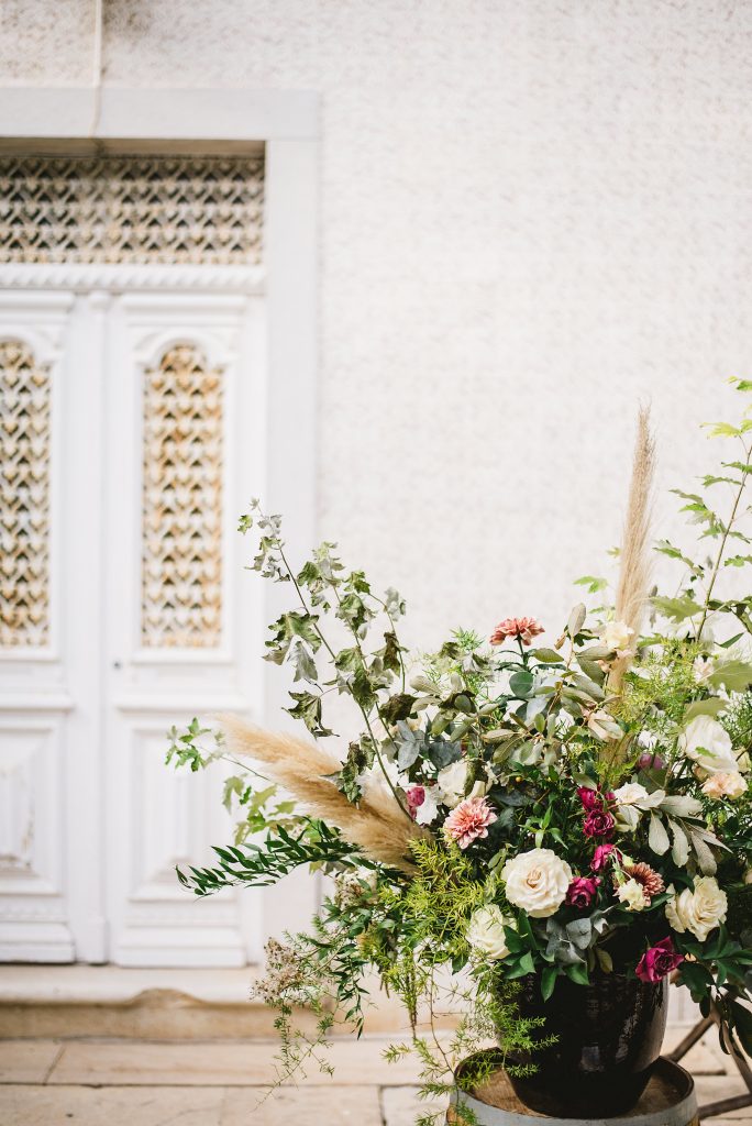 a bouquet of flowers in front of a white door